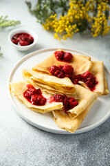 Homemade crepes with raspberry sauce