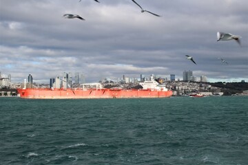container ship in the water with cloudy sky