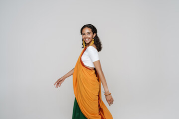 Young south asian woman wearing sari smiling while walking