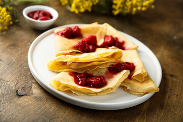 Homemade crepes with raspberry sauce