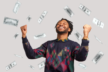 Money rain, winner and rich. Hurray. satisfied happy man with dreadlocks rising hands up with...