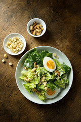 Healthy green salad with cashew and hard boiled eggs