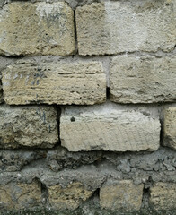 the wall is lined with large concrete blocks, bonded with cement