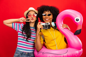 Happy smiling african woman holding flamingo rubber ring and enjoying their summer vacation .Young...