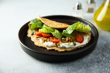 Pancake with olives and tomato
