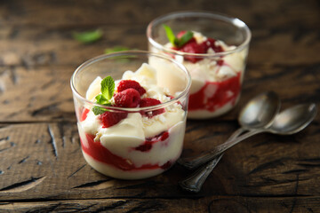 Homemade meringue trifle with custard and raspberries
