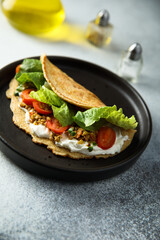 Pancake with olives and tomato