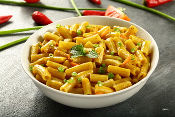 Bowl of healthy vegetarian meal- spicy cheese pasta penne.