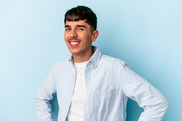 Young mixed race man isolated on blue background happy, smiling and cheerful.
