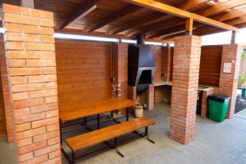Wooden table and seats from wood near hotel house