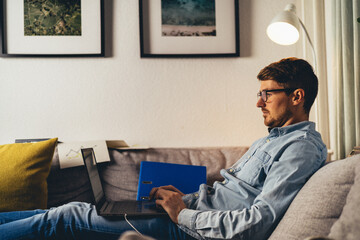 Young man working from couch