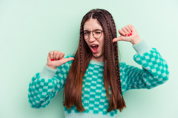 Young caucasian woman isolated on green background feels proud and self confident, example to follow.