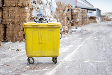 Waste and paper sorting production. The waste bin is yellow.