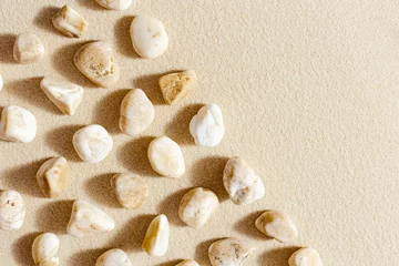 Fotobehang Zen Stenen Aesthetic minimal pattern with pebble stones on fine sand background. Top view on natural stone neutral yellow beige pastel colored image  © yrabota
