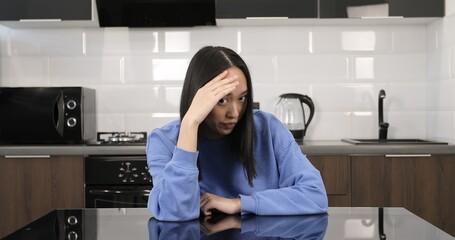 Young Asian woman is ashamed at the camera. Pretty girl hides her eyes.
