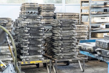 Large metal presses for the manufacture of various shapes of glass products are in stock in manufacture or factory.