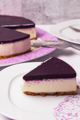 Slice of cheesecake with berries coulis on top and selective focus.