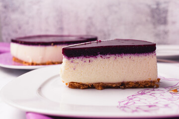 Slice of cheesecake with berries coulis on top and selective focus.