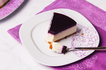 Slice of cheesecake with berries coulis on top and selective focus.