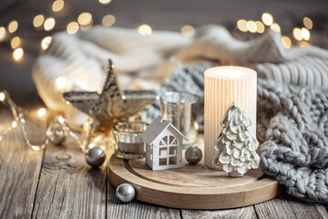 Cozy winter composition with decor details on blurred background with bokeh.