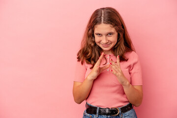 Little caucasian girl isolated on pink background making up plan in mind, setting up an idea.