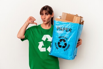 Young Argentinian woman recycled paper isolated on yellow background feels proud and self confident, example to follow.