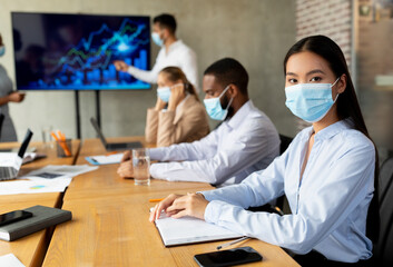 COVID-19 Office Safety. Diverse Business People In Medical Masks Attending Corporate Meeting