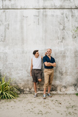 Obraz na płótnie Canvas Gay Couple standing at a wall outdoors