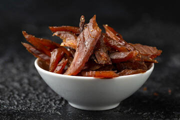 Salmon jerky Dry cured and smoked with salt and pepper - obrazy, fototapety, plakaty