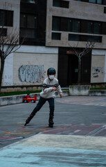 Caucasian boy practises roller skating in a city park