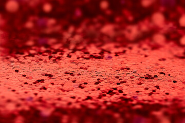 red background of bright shiny confetti in out of focus. empty copyspace layout for valentine's day template or valentine's day products