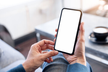 cell phone blank white screen mockup.hand holding texting using mobile on desk at office.background empty space for advertise.work people contact marketing business,technology