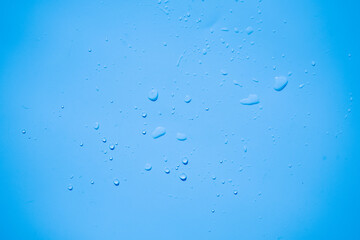 Water or rain drops on blue plastic sheet background 