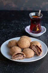 Fig cookies on a dark background. Cookies filled with fig marmalade. Close-up. Vertical view
