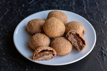 Fig cookies on a dark background. Cookies filled with fig marmalade. Close-up. Horizontal view