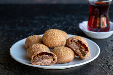 Fig cookies on a dark background. Cookies filled with fig marmalade. Close-up. Horizontal view