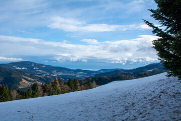 Panoramic view of alpine hills and valleys on a sunny winter day in Styria, Austria