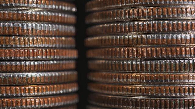 Stacks of US American coins of 25 cents quarters closeup. Background or wallpaper about economy finance banks in the USA. Dirty money from circulation. Macro