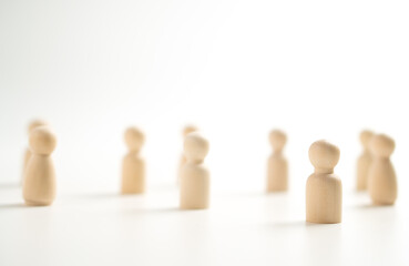 A wooden figure standing with a team to influence and empowerment. Concept of leadership,...