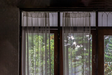 Wooden simple glass of Windows and White lace curtains with sunlight that shines through in traditional thai house, Thai Style architecture, No focus, specifically.