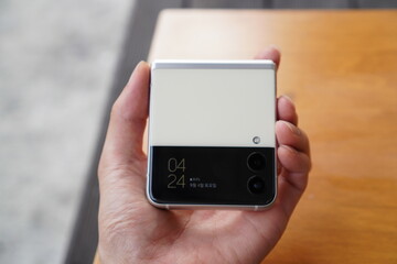 Hand holding a Samsung Galaxy Z Flip. A foldable smartphone made in south Korea.