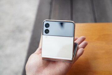 hand holding smartphone. Galaxy Z Flip, a foldable smartphone from Korea.