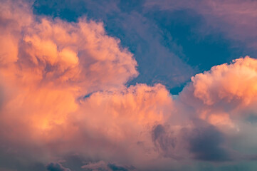 Pink clouds at sunset, unusual shape and color of the sky. Background with beautiful and bright sky
