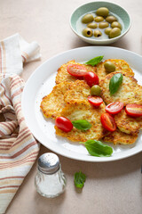 Close up of Vegan potatoes fritters with tomatoes top view food