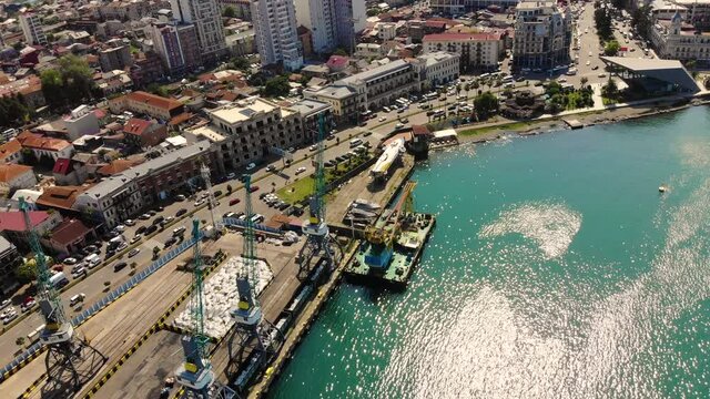 Aerial view of capital city of Batumi, Georgia, many yachts and ships in city port (marina) - landscape panorama of Europe from above.