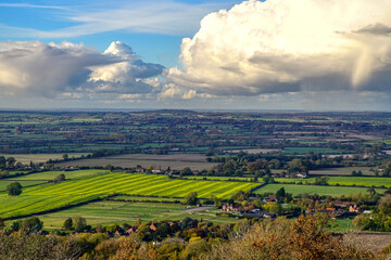 Patchwork quilt of fields in valley seen from top of high hill