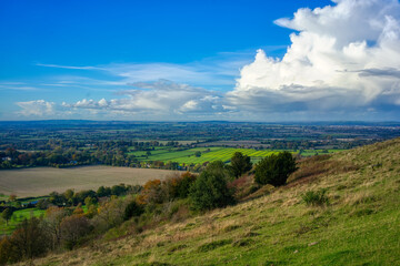 Valley and blue skies seen from high up a hill