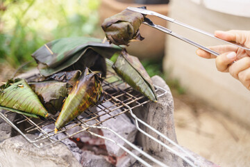 Grilling coconut sticky or glutinous rice in banana leaves