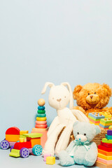Toy box full of baby kid toys. Container with teddy bear, fluffy and educational wooden toys on...