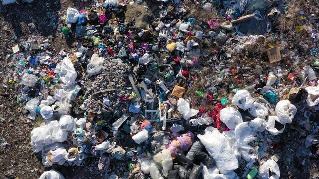 Aerial top drone view of large garbage pile, trash dump, landfill, waste from household dumping site, garbage background. Consumerism and contamination concept.